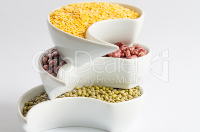 Multicolored beans in white ceramics bowl