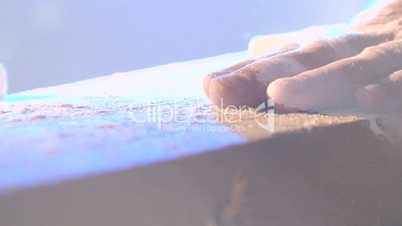 the hand of a carpenter cutting boards