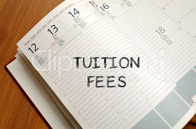 Tuition fees write on notebook