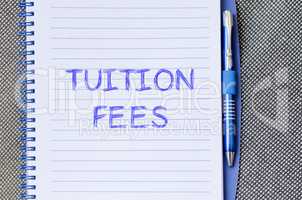 Tuition fees write on notebook