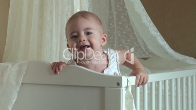 little girl playing in the crib. FullHD video