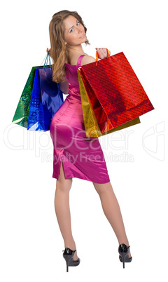 Young girl standing with her back holding shopping bags