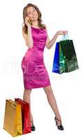 Young girl holding shopping bags and talking on the phone