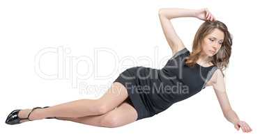 Glamorous caucasian woman lying on the floor studio isolated white background