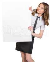 Woman looks out from behind a large blank poster