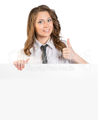 Young girl in a tie showing sign thumbs up