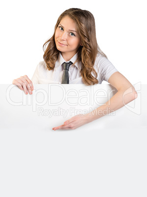 Young girl in a tie shows an empty place down