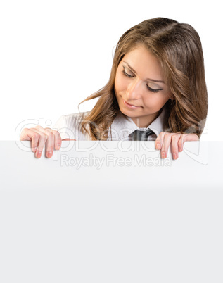 The girl looks at a blank white poster