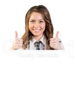 Woman stands behind a white sheet of paper and shows the thumbs-up