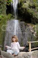 little girl meditates in nature