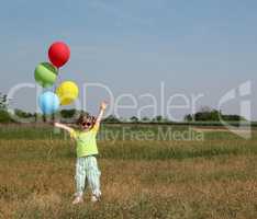 happy little girl with colorful balloons