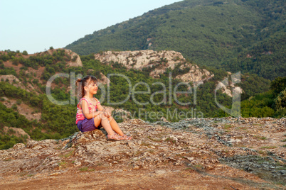 little girl looking at the mountain