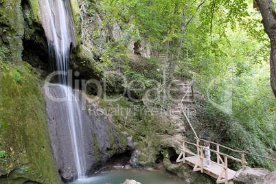 little girl looking at waterfall