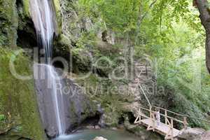 little girl looking at waterfall