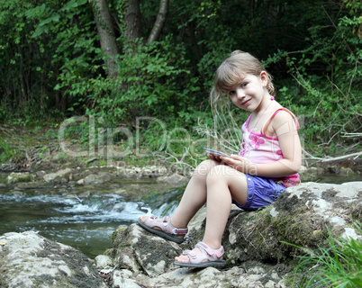 little girl posing with tablet