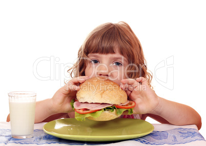 hungry little girl eat big sandwich