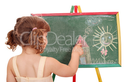 little girl drawing on board