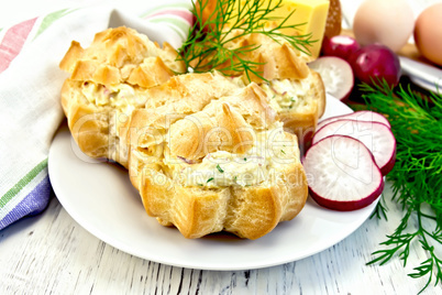 Appetizer of radish and cheese in profiteroles on white plate