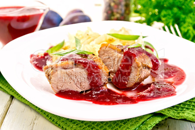 Duck breast with plum sauce and cabbage in plate