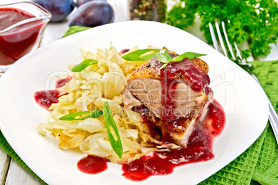 Duck breast with plum sauce and cabbage in plate