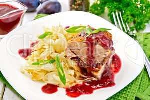 Duck breast with plum sauce and cabbage in plate