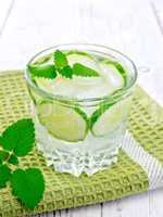 Lemonade with cucumber and mint in glassful on napkin