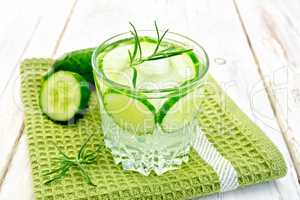 Lemonade with cucumber and rosemary in glassful on napkin