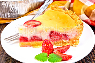 Pie strawberry with sour cream in dish on dark board