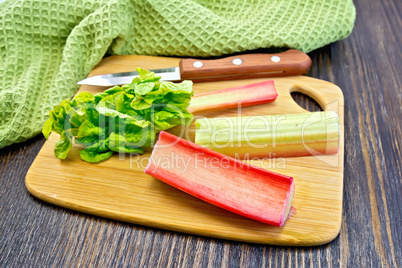 Rhubarb with knife and napkin on board