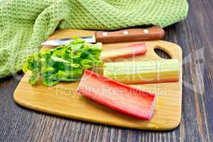 Rhubarb with knife and napkin on board