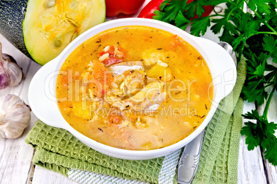 Soup fish with zucchini and peppers on napkin