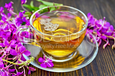 Tea from fireweed in glass cup on dark board