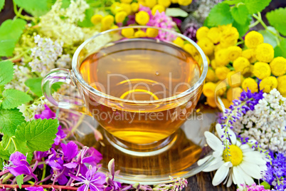 Tea from flowers in glass cup on dark board