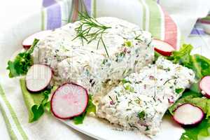 Terrine of curd and radish with salad in plate on board
