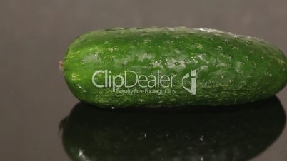 A cucumber on a black pan closeup