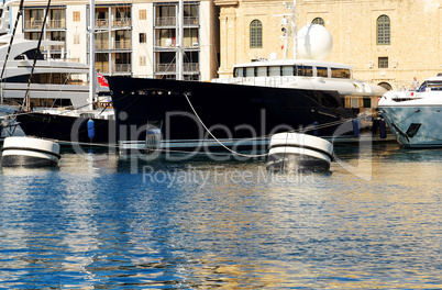 The view on Vittoriosa and modern yachts in sunset, Malta