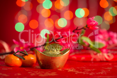 Chinese New Year decorations gold ingots on red background