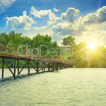 Wooden bridge over river. sunrise