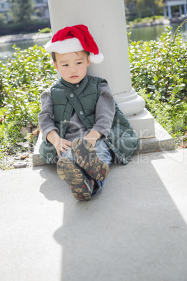 Melancholy Mixed Race Boy Wearing Christmas Santa Hat