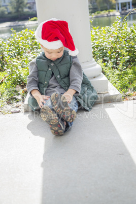 Melancholy Mixed Race Boy Wearing Christmas Santa Hat