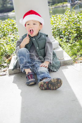 Cute Mixed Race Boy With Santa Hat and Candy Cane