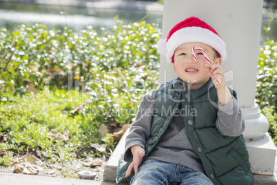 Cute Mixed Race Boy With Santa Hat and Candy Cane