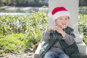 Cute Mixed Race Boy With Santa Hat and Candy Cane