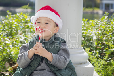 Cute Mixed Race Boy With Santa Hat and Candy Cane