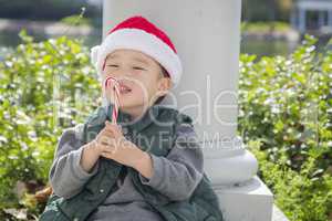 Cute Mixed Race Boy With Santa Hat and Candy Cane