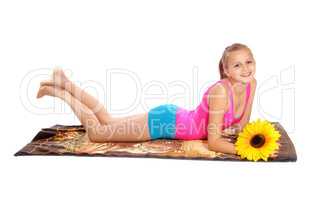 Young girl lying in bathing suit on floor.