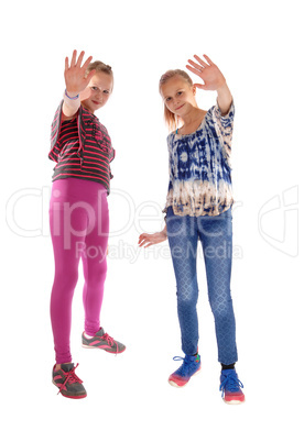 Two girls holding there hands up.