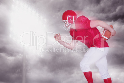 Composite image of american football player running with the bal