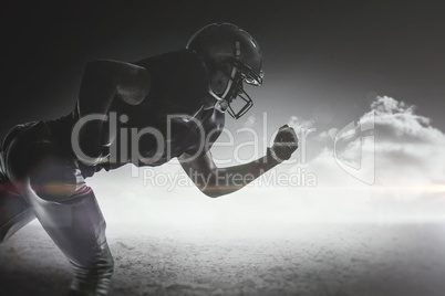 Composite image of silhouette american football player running