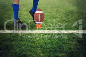 Composite image of american football player kicking ball